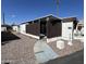 Mobile home with covered patio and gravel landscaping at 2345 E Main St # 38, Mesa, AZ 85213