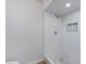 Clean shower with white tile and patterned floor at 6027 E Duncan St, Mesa, AZ 85205