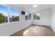 Sunroom with wood floors, large windows, and backyard view at 6027 E Duncan St, Mesa, AZ 85205