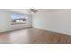 Spacious living room featuring wood flooring and large window at 6027 E Duncan St, Mesa, AZ 85205