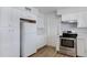Modern kitchen with white cabinets, stainless steel appliances, and quartz countertops at 6027 E Duncan St, Mesa, AZ 85205