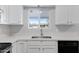 Clean kitchen with white cabinets, stainless steel appliances, and a large sink at 6027 E Duncan St, Mesa, AZ 85205