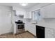 Updated kitchen, featuring white cabinets and stainless steel appliances at 6027 E Duncan St, Mesa, AZ 85205