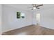 Bedroom with ceiling fan, wood-look flooring, and en-suite bathroom at 6027 E Duncan St, Mesa, AZ 85205