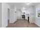 Bright kitchen with white cabinets, stainless steel appliances, and quartz countertops at 6027 E Duncan St, Mesa, AZ 85205