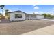 Updated ranch home with a gravel front yard and walkway at 6027 E Duncan St, Mesa, AZ 85205