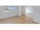 Spacious living room with light wood flooring and access to other rooms at 6027 E Duncan St, Mesa, AZ 85205