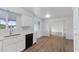 Kitchen with white cabinets, stainless steel appliances, and wood-look flooring at 6027 E Duncan St, Mesa, AZ 85205