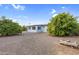 Home's back exterior showcasing a sunroom and landscaping at 6027 E Duncan St, Mesa, AZ 85205