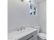 Modern bathroom with gray vanity, white sink, and toilet at 6027 E Duncan St, Mesa, AZ 85205