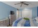 Bedroom with striped bedding, dresser, and ceiling fan at 10601 W Desert Rock Dr, Sun City, AZ 85351