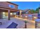 Outdoor kitchen and patio area with built-in grill and seating at 44449 W Canyon Creek Dr, Maricopa, AZ 85139