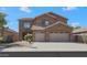 Two-story house with a three-car garage and desert landscaping at 44449 W Canyon Creek Dr, Maricopa, AZ 85139