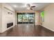 Bright living room featuring a fireplace and sliding glass doors leading to a patio at 3432 E Strawberry Dr, Gilbert, AZ 85298