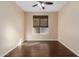 Bright bedroom with dark wood floors and ceiling fan at 3432 E Strawberry Dr, Gilbert, AZ 85298