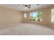 Bright bedroom with large window and ceiling fan at 3432 E Strawberry Dr, Gilbert, AZ 85298