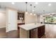 Modern kitchen with a large island, stainless steel appliances, and dark wood cabinets at 3432 E Strawberry Dr, Gilbert, AZ 85298