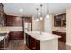 Modern kitchen with stainless steel appliances and dark wood cabinets at 3432 E Strawberry Dr, Gilbert, AZ 85298