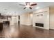 Open concept kitchen and living area with dark wood cabinets and a center island at 3432 E Strawberry Dr, Gilbert, AZ 85298