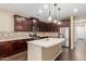 Modern kitchen with a large island, stainless steel appliances, and dark wood cabinets at 3432 E Strawberry Dr, Gilbert, AZ 85298