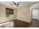 Bright bedroom with dark wood floors and ceiling fan at 3432 E Strawberry Dr, Gilbert, AZ 85298