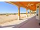 Covered porch with wood columns overlooking the desert landscape at 19999 W Fawny Ln, Casa Grande, AZ 85122