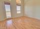 Room with wood flooring, door to patio, and large windows at 19999 W Fawny Ln, Casa Grande, AZ 85122