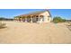 Ranch-style home with covered patio and desert landscaping at 19999 W Fawny Ln, Casa Grande, AZ 85122