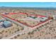 Aerial view highlighting a large desert lot with a main house and outbuildings at 19999 W Fawny Ln, Casa Grande, AZ 85122