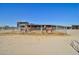 Two horses stand in an outdoor corral with a covered shelter at 19999 W Fawny Ln, Casa Grande, AZ 85122