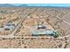 Aerial view of a desert property featuring a main house and auxiliary structures at 19999 W Fawny Ln, Casa Grande, AZ 85122