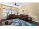 Living room featuring brown leather sofas and a blue area rug at 15316 W Sky Hawk Dr, Sun City West, AZ 85375