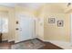 Bright and airy entryway with a white door and wood flooring at 15316 W Sky Hawk Dr, Sun City West, AZ 85375