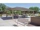 Relaxing shaded picnic area with tables, benches, and grills at 15161 W Pierce St, Goodyear, AZ 85338