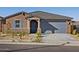 Single-story home with gray garage door and desert landscaping at 20368 N 224Th Dr, Surprise, AZ 85387