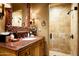 Bathroom with granite vanity and walk-in shower at 18651 N 101St Pl, Scottsdale, AZ 85255