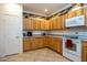 Bright kitchen with ample wood cabinets, tile flooring, and modern appliances at 8183 W Raven Dr, Arizona City, AZ 85123