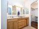 Bathroom with double vanity, wood cabinets, and shower at 8183 W Raven Dr, Arizona City, AZ 85123