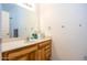 Bathroom with wood vanity and large mirror at 8183 W Raven Dr, Arizona City, AZ 85123