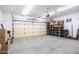 Garage with overhead door and storage shelves at 8183 W Raven Dr, Arizona City, AZ 85123