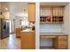 Kitchen with built-in desk, wood cabinets, and tile flooring at 8183 W Raven Dr, Arizona City, AZ 85123