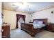 Spacious bedroom with wood sleigh bed, ceiling fan, and ample closet space at 8183 W Raven Dr, Arizona City, AZ 85123