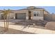 New construction home with gray exterior, two-car garage, and small front yard at 15399 W Desert Hollow Dr, Surprise, AZ 85387