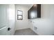 Well-appointed laundry room with dark cabinets and herringbone flooring at 6731 N 9Th Dr, Phoenix, AZ 85013