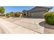 Tan house with a two-car garage and desert landscaping at 43809 W Elm Dr, Maricopa, AZ 85138