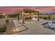Outdoor kitchen and dining area adjacent to a refreshing pool at 15201 S 183Rd Dr, Goodyear, AZ 85338
