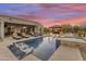 Luxury backyard oasis featuring a sparkling pool, spa, and inviting patio at 15201 S 183Rd Dr, Goodyear, AZ 85338