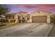 Beautiful home exterior with desert landscaping and two-car garage at 15201 S 183Rd Dr, Goodyear, AZ 85338