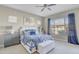 Spacious main bedroom with blue and white bedding and a sitting area at 15201 S 183Rd Dr, Goodyear, AZ 85338