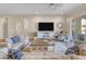 Bright living room featuring comfortable seating and a large flat-screen TV at 15201 S 183Rd Dr, Goodyear, AZ 85338